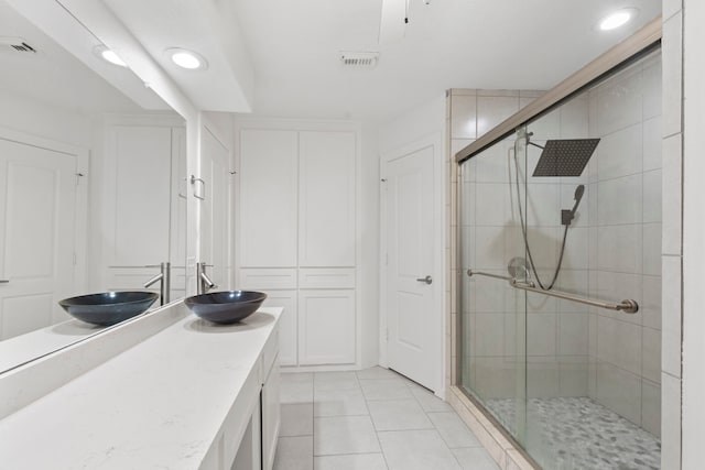 9222 New Forest Rd, Spring, TX 77379 - bathroom with a shower stall, double vanity, tile patterned flooring, and recessed lighting