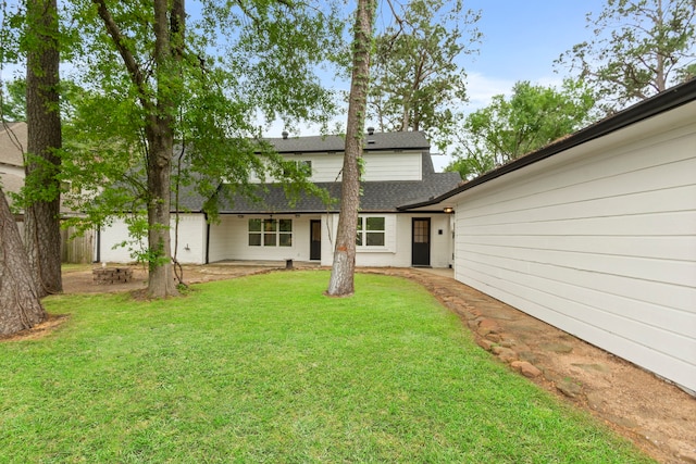 9222 New Forest Rd, Spring, TX 77379 - rear view of house with a shingled roof, a yard, and a patio