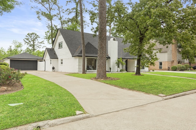 9222 New Forest Rd, Spring, TX 77379 - view of front of house with roof with shingles, brick siding, a front lawn, and concrete driveway