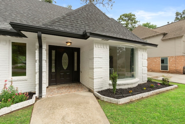 9222 New Forest Rd, Spring, TX 77379 - view of exterior entry featuring roof with shingles and brick siding