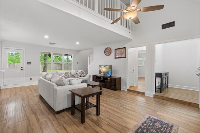 9222 New Forest Rd, Spring, TX 77379 - living room featuring plenty of natural light, light wood-style floors, ceiling fan, a high ceiling, and recessed lighting