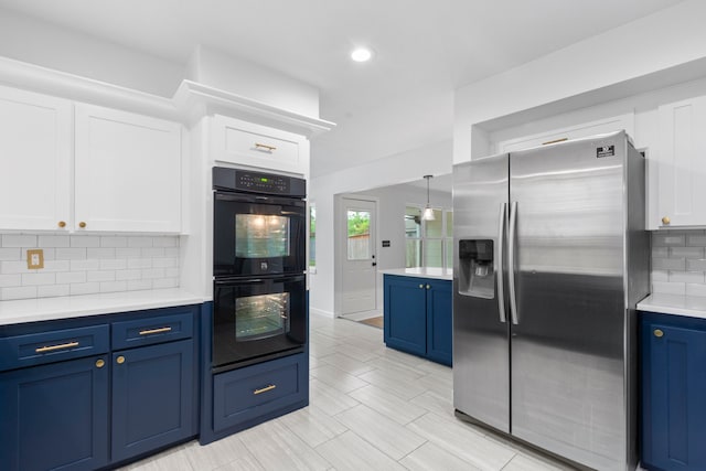 9222 New Forest Rd, Spring, TX 77379 - kitchen with stainless steel fridge, blue cabinetry, light countertops, white cabinets, and recessed lighting