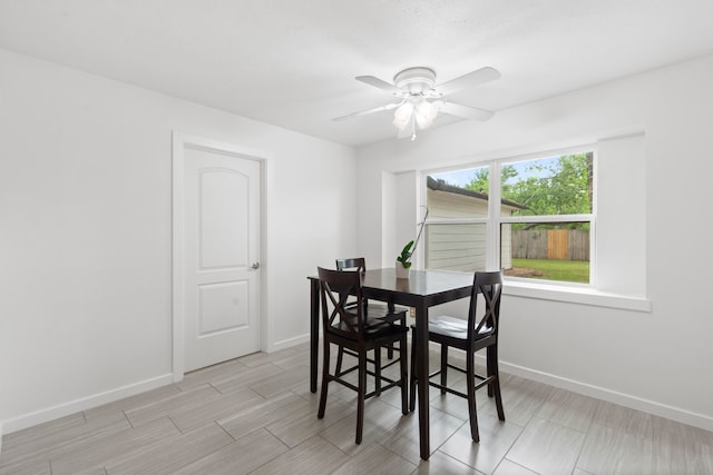 9222 New Forest Rd, Spring, TX 77379 - dining room featuring baseboards, ceiling fan, and wood tiled floors