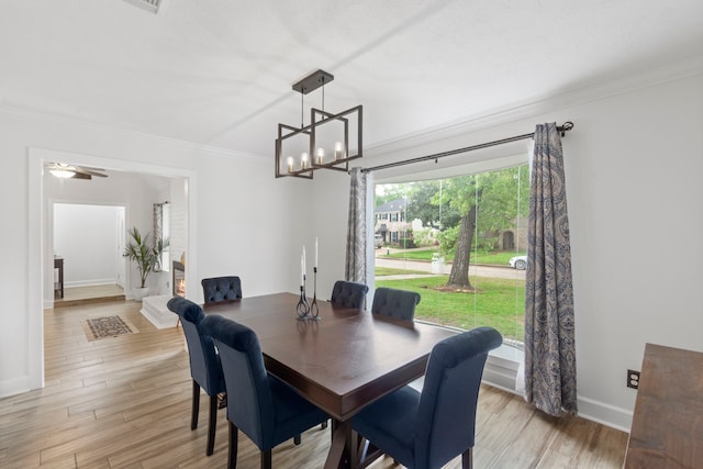 9222 New Forest Rd, Spring, TX 77379 - dining space with ornamental molding, baseboards, a chandelier, and light wood-type flooring