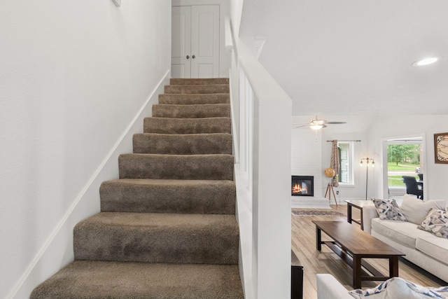 9222 New Forest Rd, Spring, TX 77379 - staircase with wood finished floors, a brick fireplace, and recessed lighting