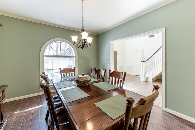 18 Village Hill Dr, Conroe, TX 77304 - dining room with crown molding, a chandelier, stairway, hardwood / wood-style floors, and baseboards
