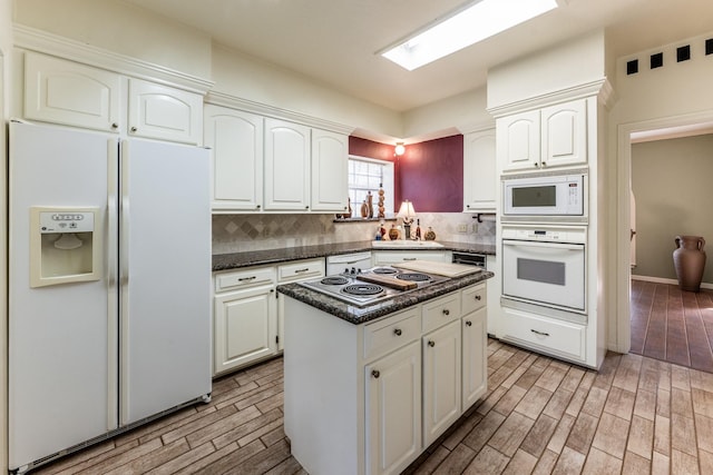 18 Village Hill Dr, Conroe, TX 77304 - kitchen featuring white appliances, tasteful backsplash, light wood-style floors, white cabinets, and a kitchen island