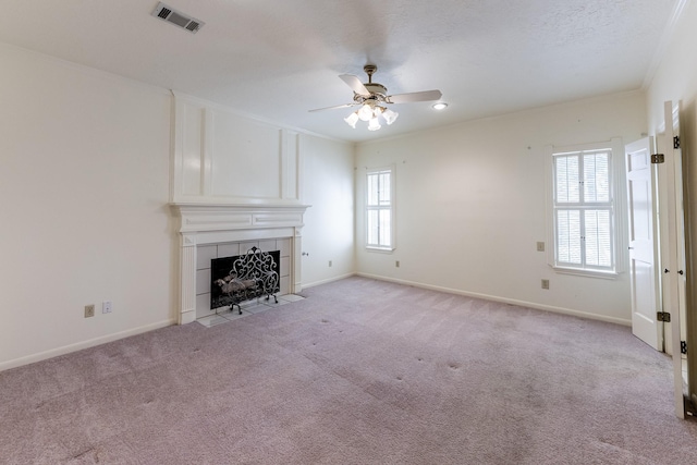 18 Village Hill Dr, Conroe, TX 77304 - unfurnished living room with healthy amount of natural light, a fireplace, a ceiling fan, light colored carpet, and ornamental molding