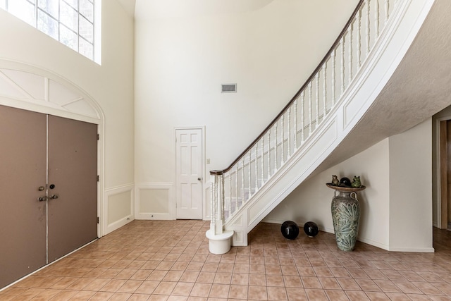 18 Village Hill Dr, Conroe, TX 77304 - entryway featuring a high ceiling, light tile patterned floors, and stairway