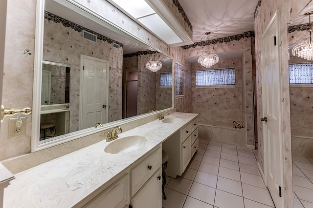 18 Village Hill Dr, Conroe, TX 77304 - bathroom featuring double vanity, tile patterned floors, a garden tub, a chandelier, and wallpapered walls