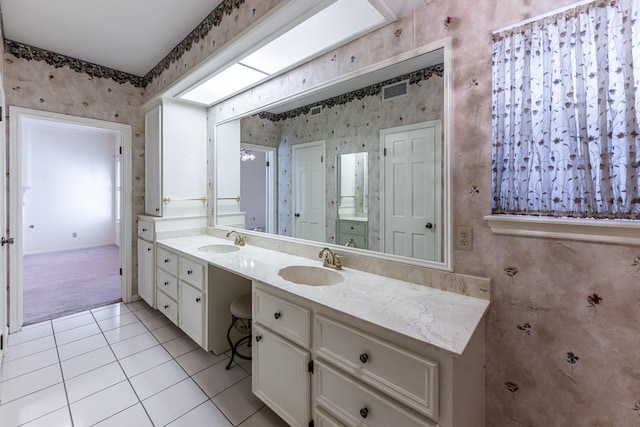 18 Village Hill Dr, Conroe, TX 77304 - bathroom with wallpapered walls, double vanity, tile patterned flooring, and baseboards
