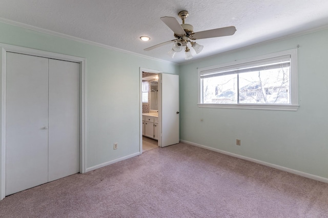 18 Village Hill Dr, Conroe, TX 77304 - unfurnished bedroom with crown molding, light colored carpet, baseboards, a textured ceiling, and ensuite bathroom