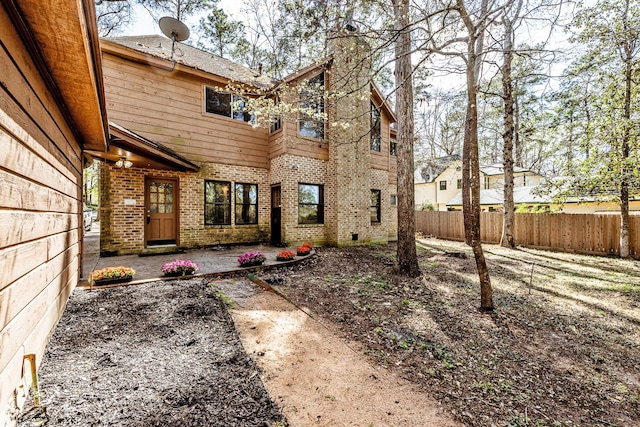 18 Village Hill Dr, Conroe, TX 77304 - back of house featuring a chimney, brick siding, and a patio area