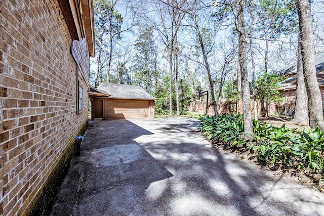 18 Village Hill Dr, Conroe, TX 77304 - view of home's exterior with driveway, a garage, and a shingled roof
