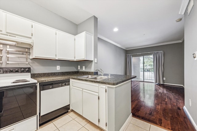 3231 Allen Pkwy Unit 6205, Houston, TX 77019 - kitchen with white dishwasher, range with electric cooktop, under cabinet range hood, a sink, and dark countertops