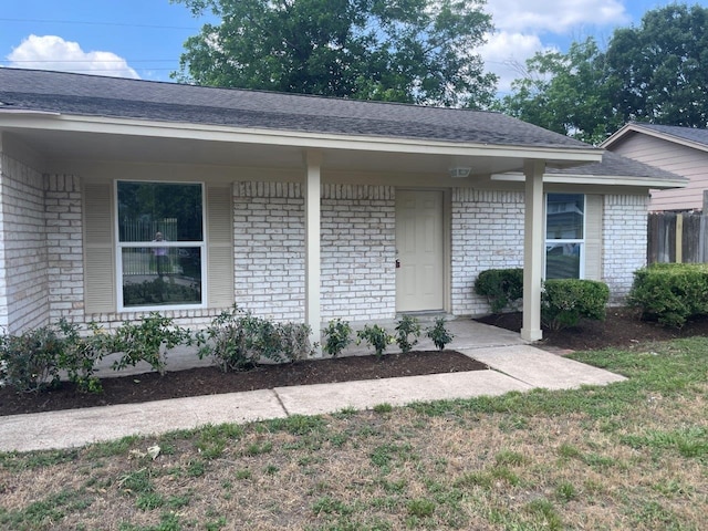 19414 Leafwood Ln, Houston, TX 77084 - property entrance with brick siding, roof with shingles, and covered porch