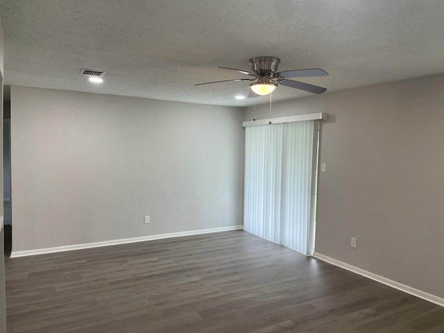 19414 Leafwood Ln, Houston, TX 77084 - unfurnished room with ceiling fan, baseboards, dark wood finished floors, and a textured ceiling