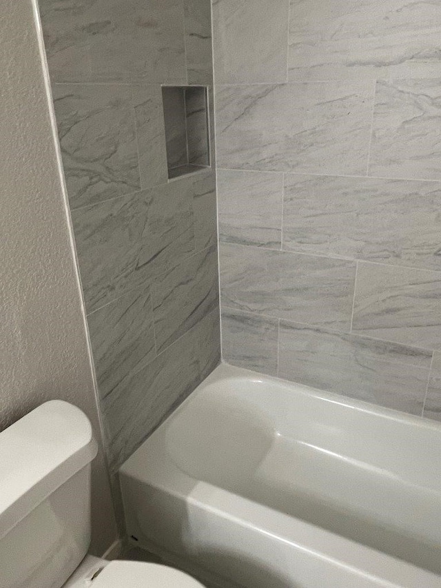 19414 Leafwood Ln, Houston, TX 77084 - full bath with toilet,  shower combination, and a textured wall
