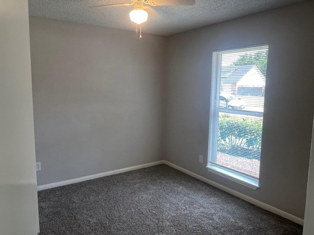19414 Leafwood Ln, Houston, TX 77084 - spare room featuring healthy amount of natural light, a ceiling fan, dark colored carpet, a textured ceiling, and baseboards