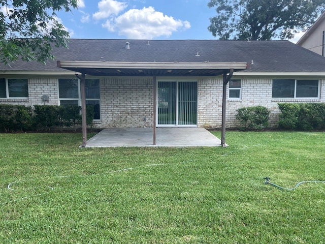 19414 Leafwood Ln, Houston, TX 77084 - back of house with a patio, a yard, brick siding, and roof with shingles