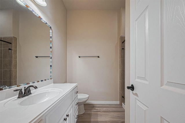 5442 Jackson Park Ln, Katy, TX 77494 - bathroom featuring vanity, wood finished floors, toilet, and a shower