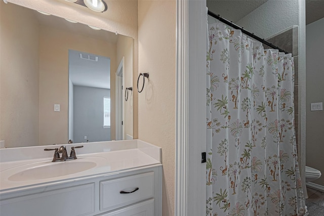 5442 Jackson Park Ln, Katy, TX 77494 - full bathroom with vanity, toilet, a shower with curtain, and a textured wall