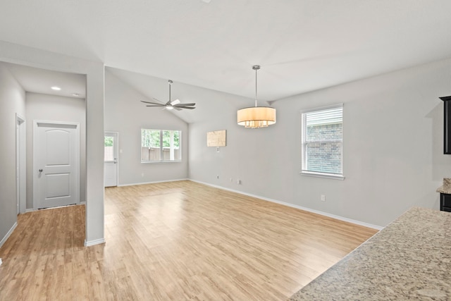 18061 Atwood Mill Dr, New Caney, TX 77357 - unfurnished living room featuring light wood-type flooring, baseboards, and vaulted ceiling