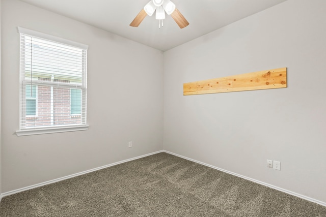 18061 Atwood Mill Dr, New Caney, TX 77357 - empty room with healthy amount of natural light, dark colored carpet, a ceiling fan, and baseboards