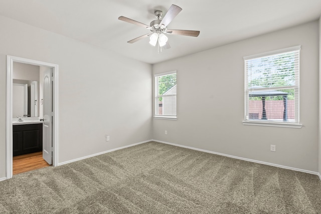 18061 Atwood Mill Dr, New Caney, TX 77357 - spare room featuring light colored carpet, ceiling fan, and baseboards