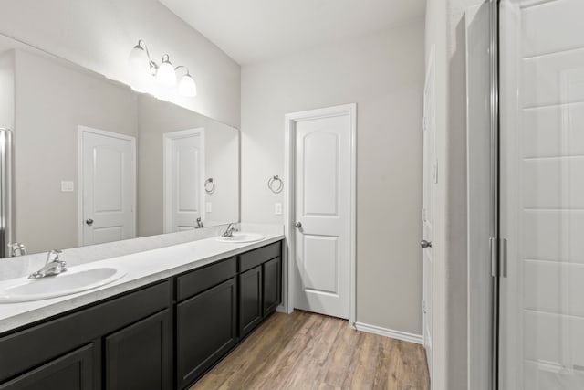 18061 Atwood Mill Dr, New Caney, TX 77357 - full bathroom featuring double vanity and wood finished floors