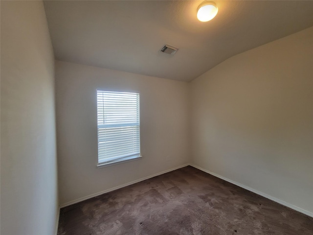 18214 Olive Leaf Dr, Houston, TX 77084 - spare room featuring vaulted ceiling, dark colored carpet, and baseboards