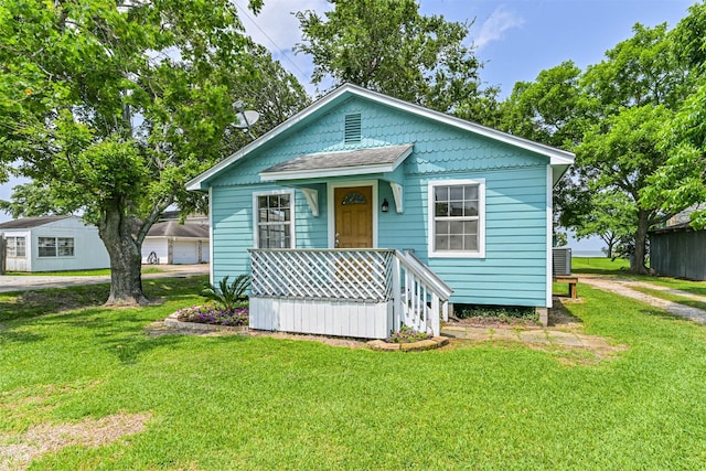 4803 W Bayshore Dr, Bacliff, TX 77518 - view of front of home with a front lawn, central AC, and covered porch