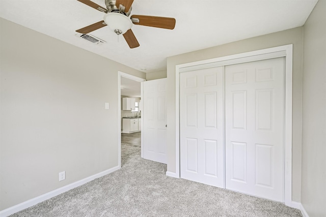 4803 W Bayshore Dr, Bacliff, TX 77518 - unfurnished bedroom with carpet, baseboards, a closet, and ceiling fan