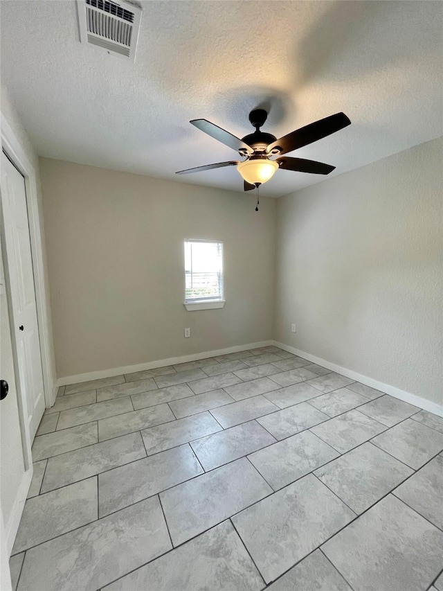 527 W 4th St, Freeport, TX 77541 - unfurnished room featuring a textured ceiling, a ceiling fan, and baseboards