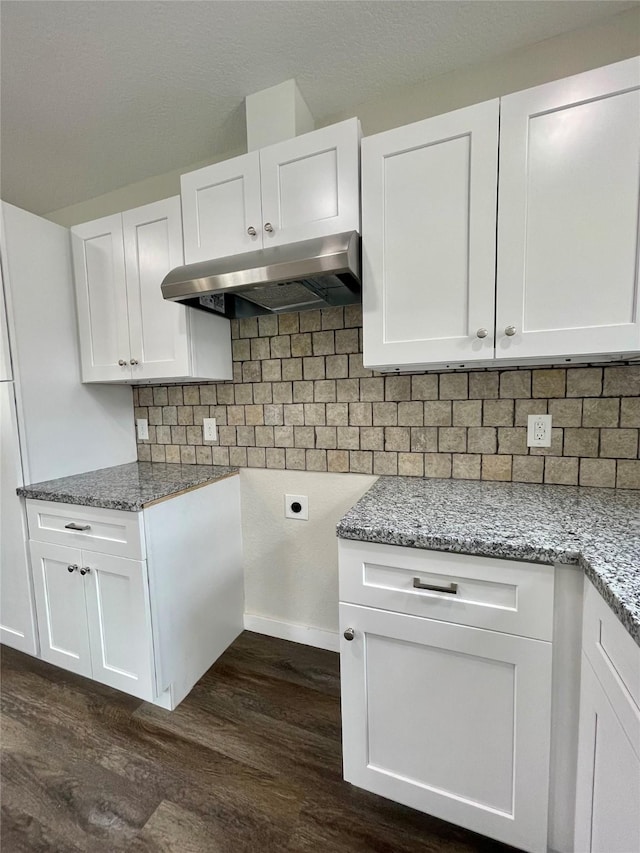 527 W 4th St, Freeport, TX 77541 - kitchen with under cabinet range hood, dark wood-type flooring, and light stone counters