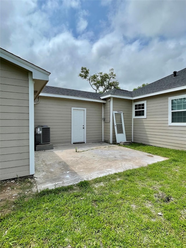 527 W 4th St, Freeport, TX 77541 - back of house with central AC, a patio, and a yard