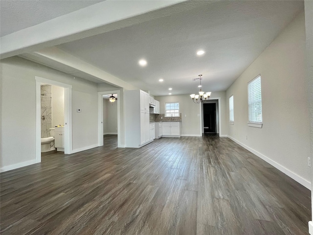 527 W 4th St, Freeport, TX 77541 - unfurnished living room with a chandelier, baseboards, dark wood-style flooring, recessed lighting, and a ceiling fan