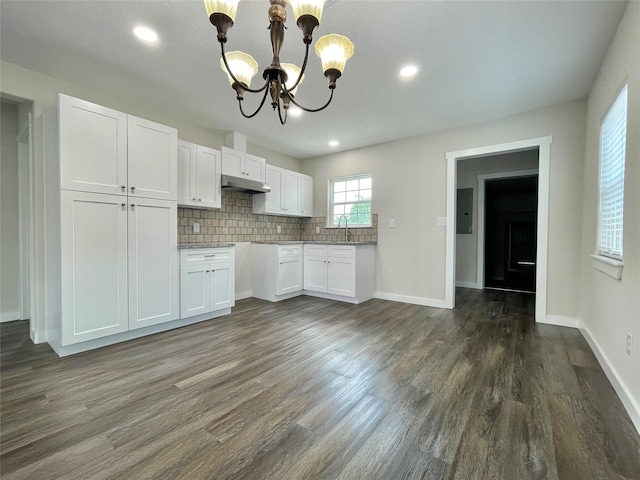 527 W 4th St, Freeport, TX 77541 - kitchen with under cabinet range hood, a chandelier, white cabinets, dark wood-style flooring, and recessed lighting