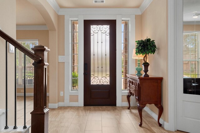 19023 Wild Thornberry Dr, Tomball, TX 77377 - entrance foyer with crown molding, arched walkways, baseboards, and stairs