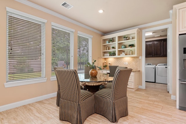 19023 Wild Thornberry Dr, Tomball, TX 77377 - dining room with washing machine and dryer, crown molding, baseboards, and recessed lighting