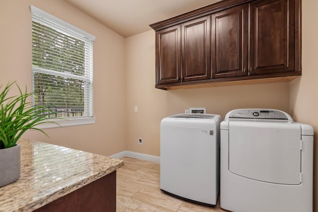 19023 Wild Thornberry Dr, Tomball, TX 77377 - laundry room featuring independent washer and dryer, cabinet space, healthy amount of natural light, and baseboards