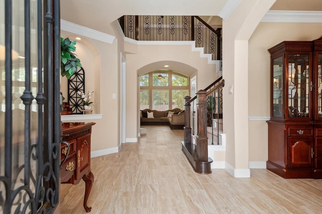 19023 Wild Thornberry Dr, Tomball, TX 77377 - foyer with arched walkways, stairs, baseboards, a towering ceiling, and crown molding