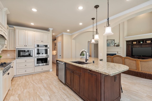 19023 Wild Thornberry Dr, Tomball, TX 77377 - kitchen with stainless steel appliances, a sink, recessed lighting, light stone countertops, and an island with sink