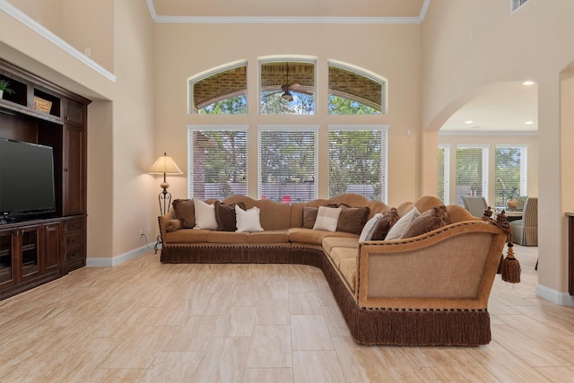 19023 Wild Thornberry Dr, Tomball, TX 77377 - living room with arched walkways, baseboards, crown molding, and a high ceiling
