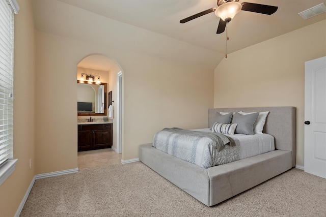 19023 Wild Thornberry Dr, Tomball, TX 77377 - bedroom featuring light colored carpet, baseboards, arched walkways, and connected bathroom