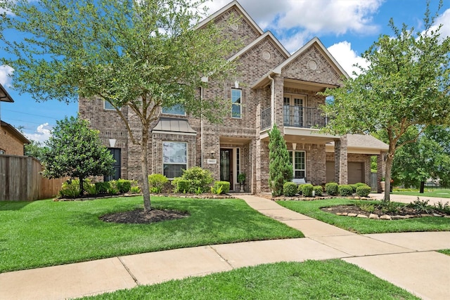 19023 Wild Thornberry Dr, Tomball, TX 77377 - view of front of house featuring a balcony, brick siding, and a garage