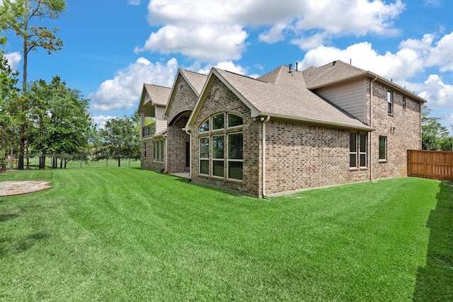 19023 Wild Thornberry Dr, Tomball, TX 77377 - rear view of property featuring a shingled roof and brick siding