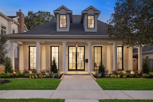 711 E 12th St, Houston, TX 77008 - view of front of house featuring a shingled roof, a front yard, and a porch