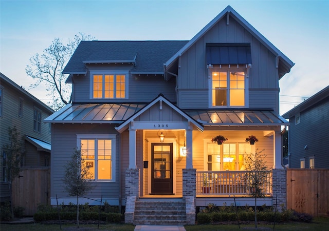 711 E 12th St, Houston, TX 77008 - craftsman-style house with a standing seam roof, covered porch, board and batten siding, and metal roof