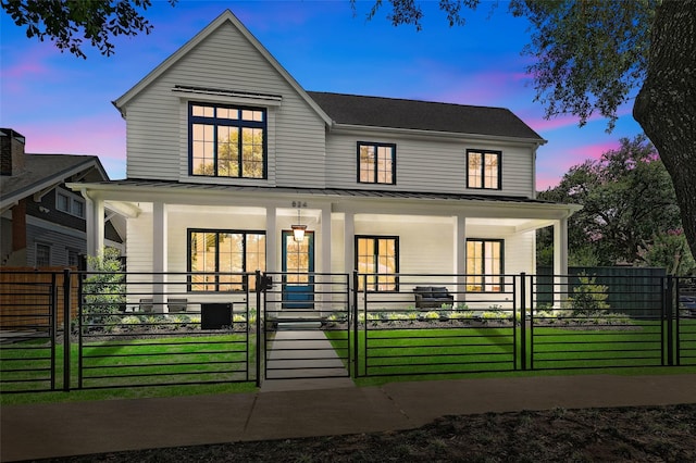 711 E 12th St, Houston, TX 77008 - view of front of home with covered porch, a gate, and a standing seam roof